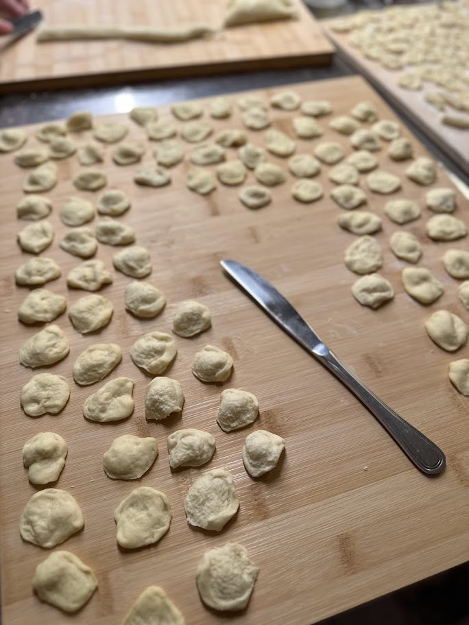 Cooking class preparing orecchiette pasta and traditional Apulian dishes.